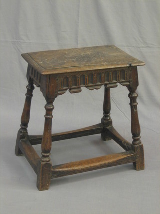 An 18th/19th Century rectangular oak joyned stool with arcaded decoration, raised on turned and block supports (top weathered) 17"