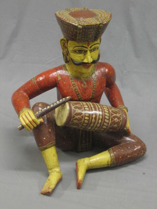 A carved Indian hardwood figure of a drummer 26"