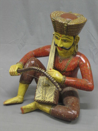 A carved Indian hardwood figure of a musician 26"