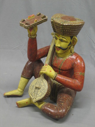 A carved Indian hardwood figure of a musician 26"