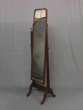 A 1930's arched cheval mirror contained in a walnut swing frame