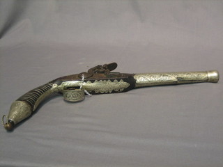 An Eastern flint lock pistol with engraved silver mounts and 9" circular barrel (no ram rod)