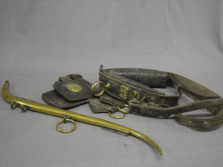 A pair of leather and brass blinkers, a section of driving harness marked P.C & CCO together with a brass horse hame