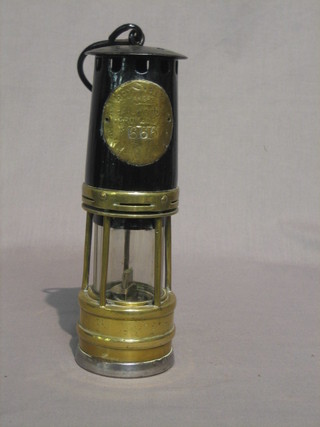 A Miner's safety lamp by Hall Woods