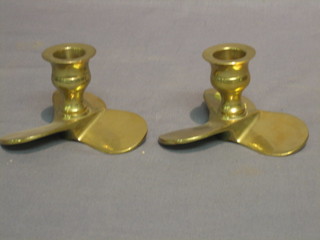 A pair of stub candlesticks, the bases in the form of propellers 2"