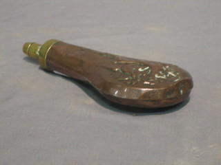 A 19th Century embossed copper and brass powder flask (with old solder repair to the side) 7"