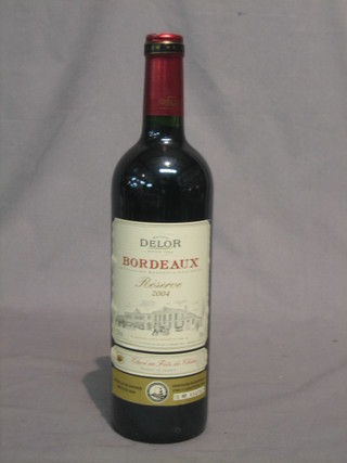 A bottle of 2000 Clos Cotes Pecharmant, a bottle of 2002 Coeur Des Remparts Bordeaux, a bottle of 2003 Madiran and a bottle of 2004 Delor Bordeaux