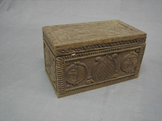 A carved Eastern hardwood trinket box with hinged lid 11"