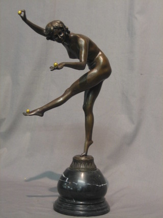 A reproduction Art Deco style figure of a standing bronze naked lady balancing 3 balls on her hands and feet, raised on a marble base 17"