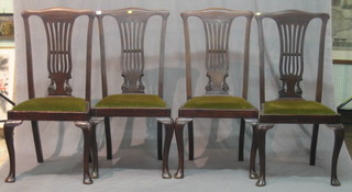 A set of 4 Hepplewhite style mahogany dining chairs with vase splat backs and upholstered seats, raised on cabriole supports