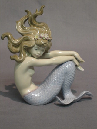 A Lladro figure of a seated Mermaid 7"