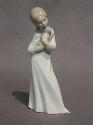 A Nao figure of a  standing girl with puppy dog, the base marked Nao 8"