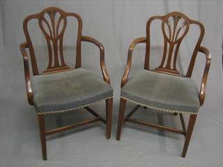 A pair of Georgian style mahogany open arm carver chairs