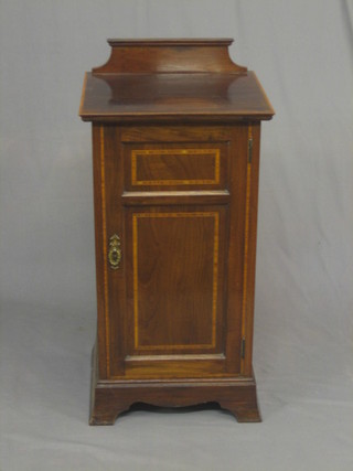 An Edwardian inlaid mahogany pedestal side cabinet enclosed by a panelled door, raised on bracket feet 17"