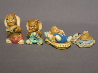 4  Pendelfin figures,  rabbit in bed, rabbit with pepper pot, reclining rabbit on a bed and a rabbit reading a musical book