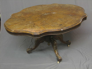 A Victorian oval figured walnut Loo table, raised on a carved tripod column base, 56" (veneers bubbling and some water damage)