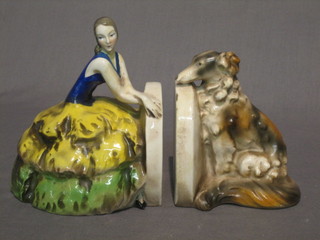 A pair of Goebel Art Deco pottery book ends in the form of seated Crinoline lady and an Afghan hound (1 base with crack)