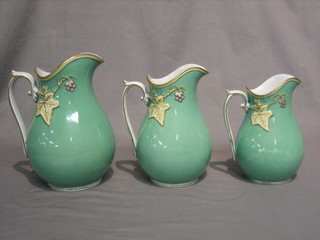 A set of 3 19th Century green glazed jugs with vinery decoration (some rubbing)