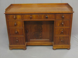 A Victorian mahogany kneehole pedestal dressing table with three quarter gallery, fitted 1 long and 8 short drawers, the pedestal fitted a cupboard enclosed by panelled door 50"
