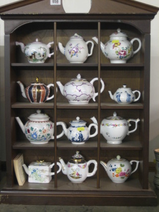 12 Franklyn mint reproduction Oriental style teapots contained in a display case