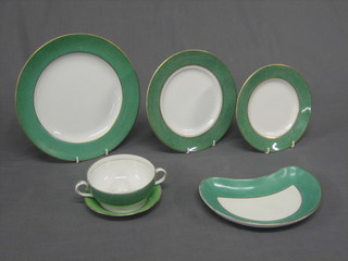 A 43 piece Booths green and gilt dinner/tea service comprising 16" oval meat plate, 5 dinner plates 10", 6 side plates 8 1/2" (1 with chips to rim), a side plate 10", 6 side plates 8", 5 tea plates 7" (1 with chip to rim), 8 various saucers, 7 twin handled soup bowls (2 with damaged handles), 4 crescent shaped salad plates - all crazed and worn