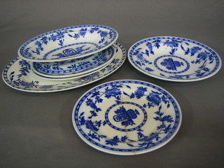 A 26 piece Mintons Delft pattern blue and white dinner service comprising, 2 oval tureen stands 9 1/2" (1 cracked), an oval dish 11" (cracked and chipped), 7 dinner plates 10" (1 chipped), 8 soup bowls 10", 7 side plates 9" (2 cracked, 1 chipped)  together with an oval Wedgwood meat plate 14"