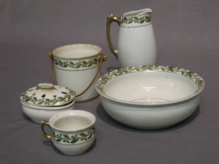 A childs miniature 5 piece wash set comprising jug and bowl, slop pail, chamber pot and soap dish, with green acorn banding