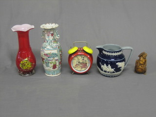 A Chinese carved wooden figure, a blue and white Copeland Spode jug, a red glass vase and an Oriental Canton vase
