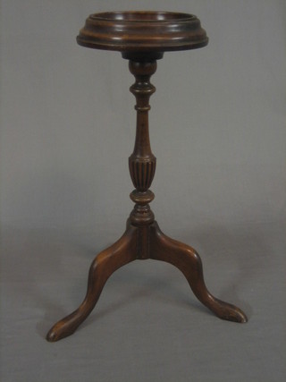 A 1930's reproduction Georgian wig stand, raised on turned pillar and tripod supports