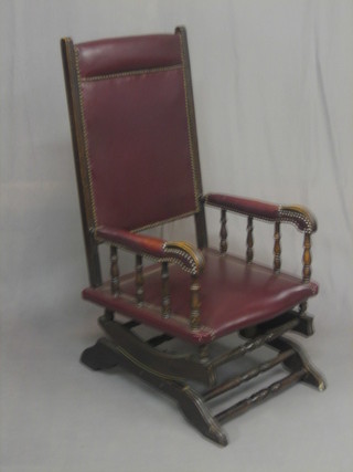An American rocking chair, the seat upholstered in red leather