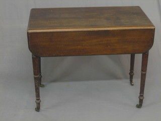 A 19th Century mahogany Pembroke table, fitted a frieze drawer and raised on ring turned supports 26"