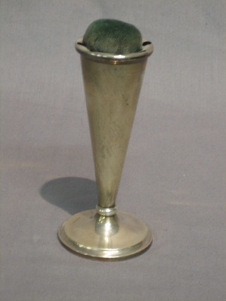An Edwardian trumpet shaped silver pin cushion holder, raised on a circular spreading foot, Birmingham 1910 5 1/2"