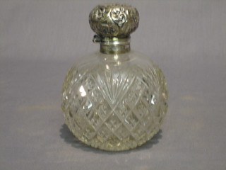 A globular shaped cut glass scent bottle with hinged silver lid (f) 3"