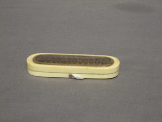 A 19th Century oval ivory toothpick/needle case the hinged lid with hair sculpture 3 1/2" (hinge f)
