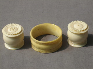 A turned ivory napkin ring and a turned ivory salt and pepper pot