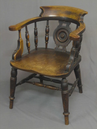 An elm captain's chair with bobbin splat back and solid elm seat, raised on turned supports