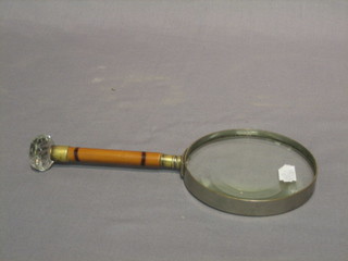 A 19th Century circular magnifying glass with bamboo and faceted glass handle (glass chipped to rim)