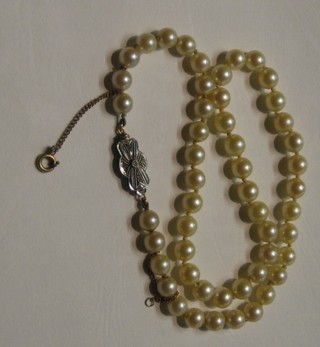 An Edwardian rope of 51 pearls with diamond set clasp, 15"