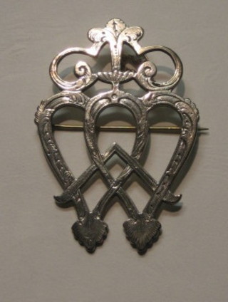 A pierced silver Art Nouveau brooch