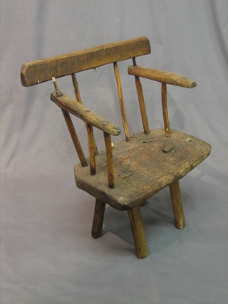 A rustic elm stick and bar back carver chair