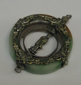 A circular "jade" and silver pendant set a figure of Buddha