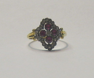 A lady's 18ct gold dress ring set 4 rubies supported by numerous diamonds