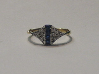 A lady's 18ct gold dress ring set 4 square cut sapphires supported by diamonds