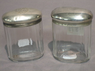 A Victorian oval glass dressing table jar with silver collar, London 1891, a similar jar and a salt bottle with silver collar