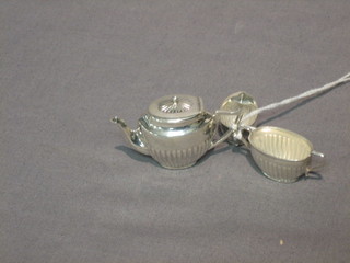 A 20th Century miniature Sterling silver tea set comprising teapot, twin handled sugar bowl and cream jug, all with demi-reeded decoration