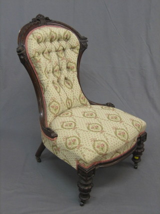 A  Victorian  carved mahogany spoon back  chair  upholstered  in button backed material, raised on turned supports
