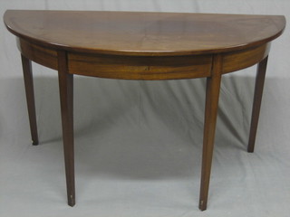 A  19th  Century  mahogany demi-lune  table,  raised  on  square tapering supports 52"