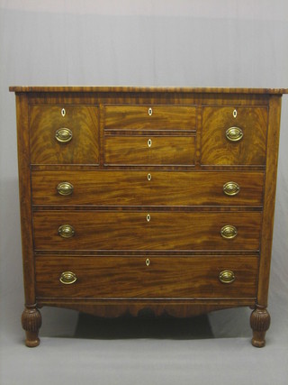 A William IV mahogany chest, fitted 2 short drawers flanked  by 2  large drawers, the base fitted 4 long drawers, raised on  turned and reeded supports 49"