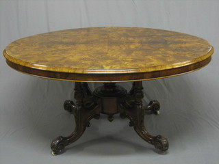 A Victorian figured walnut oval snap top Loo table, raised on 4  well carved column supports with splayed feet 58" 