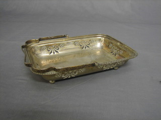 A rectangular pierced silver plated cake basket with swing handle